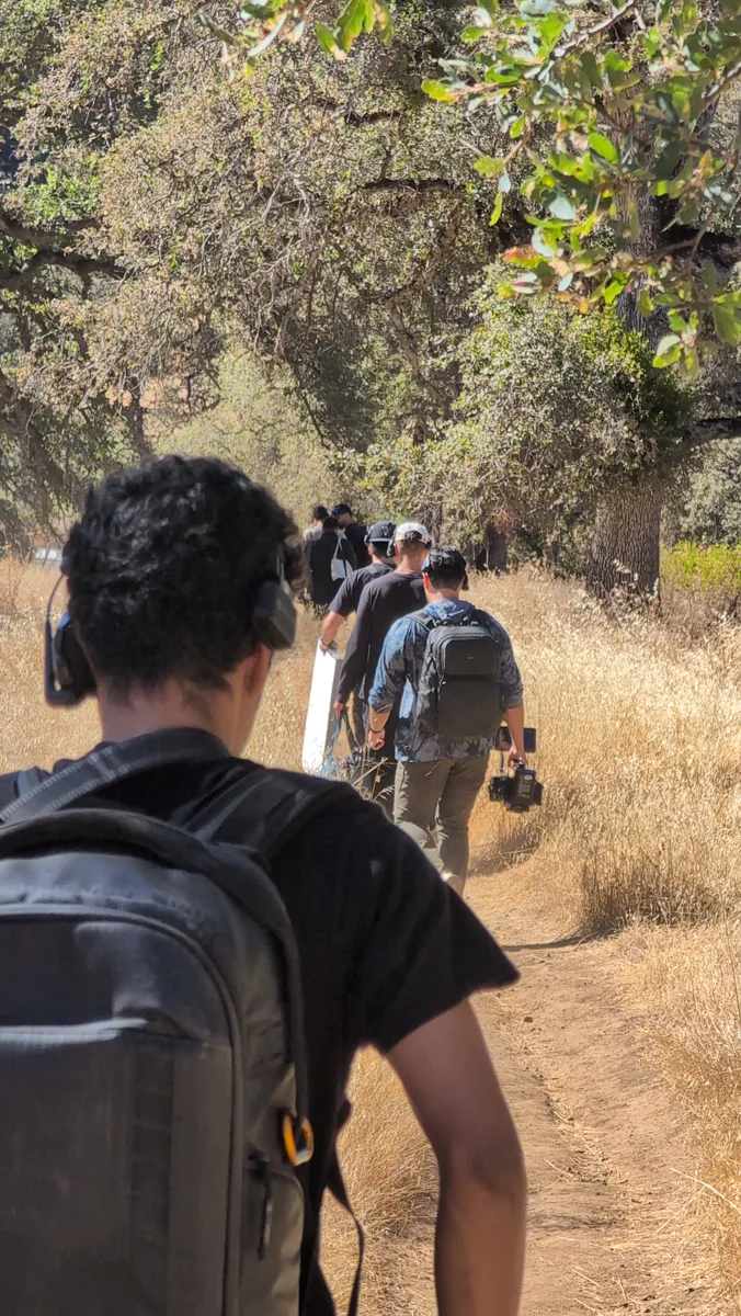 Behind the scenes: production crew walking into a location